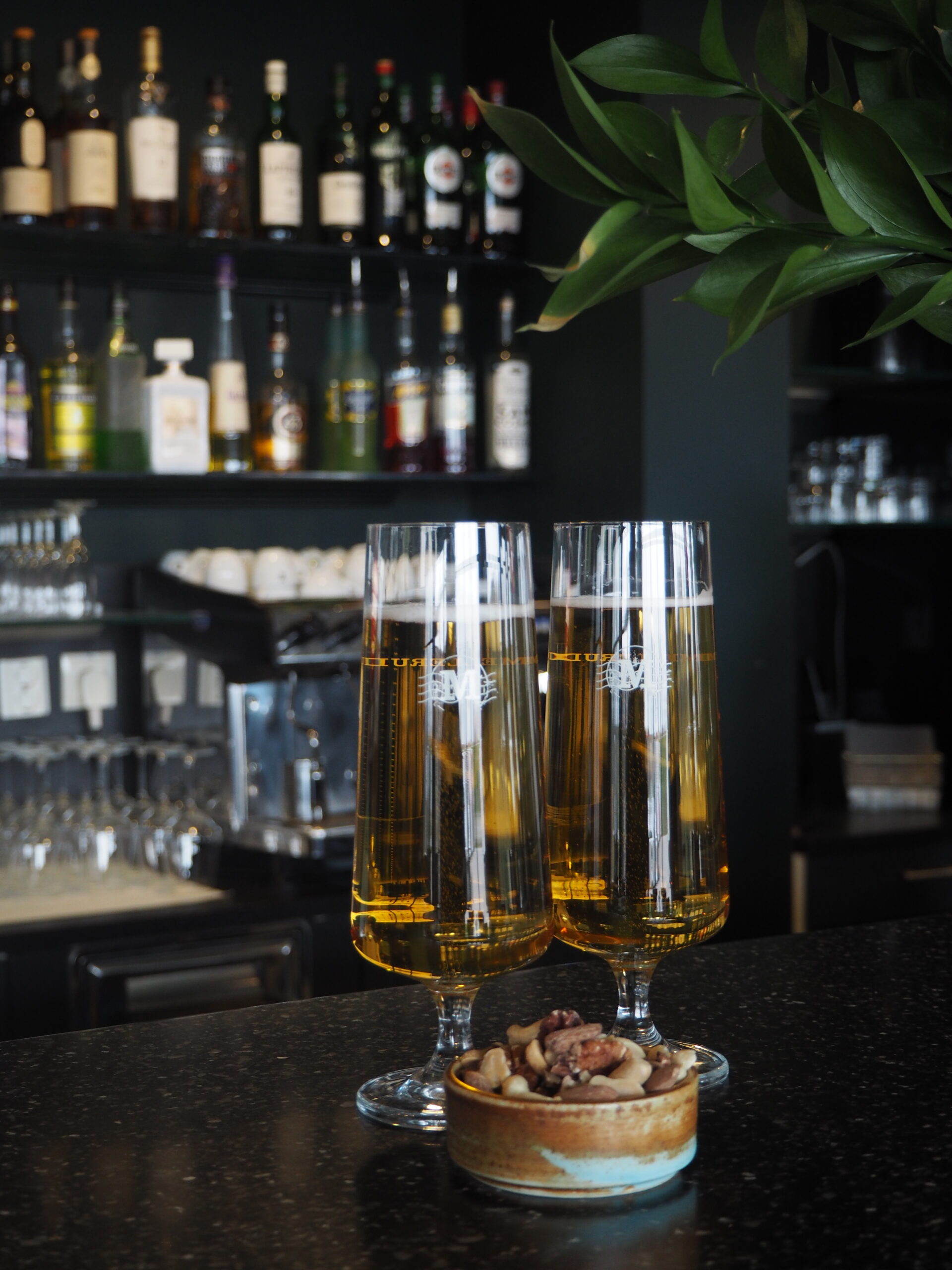 Två champagneglas och nötter på bardisk